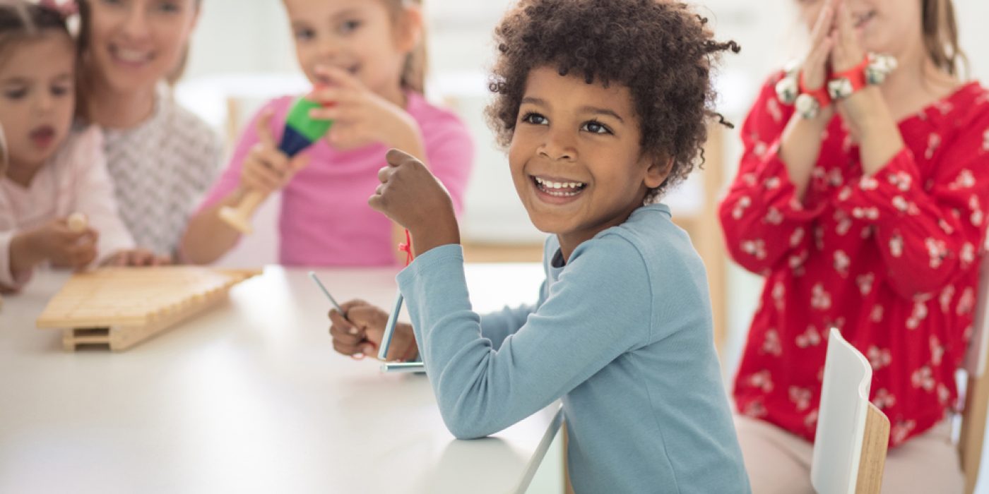crianças sorriem em sala de aula da Educação Infantil